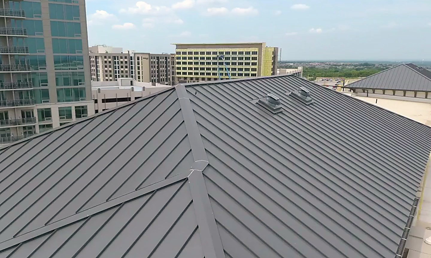 Dark standing seam metal roofing on the Domain at the Gate apartment buildings