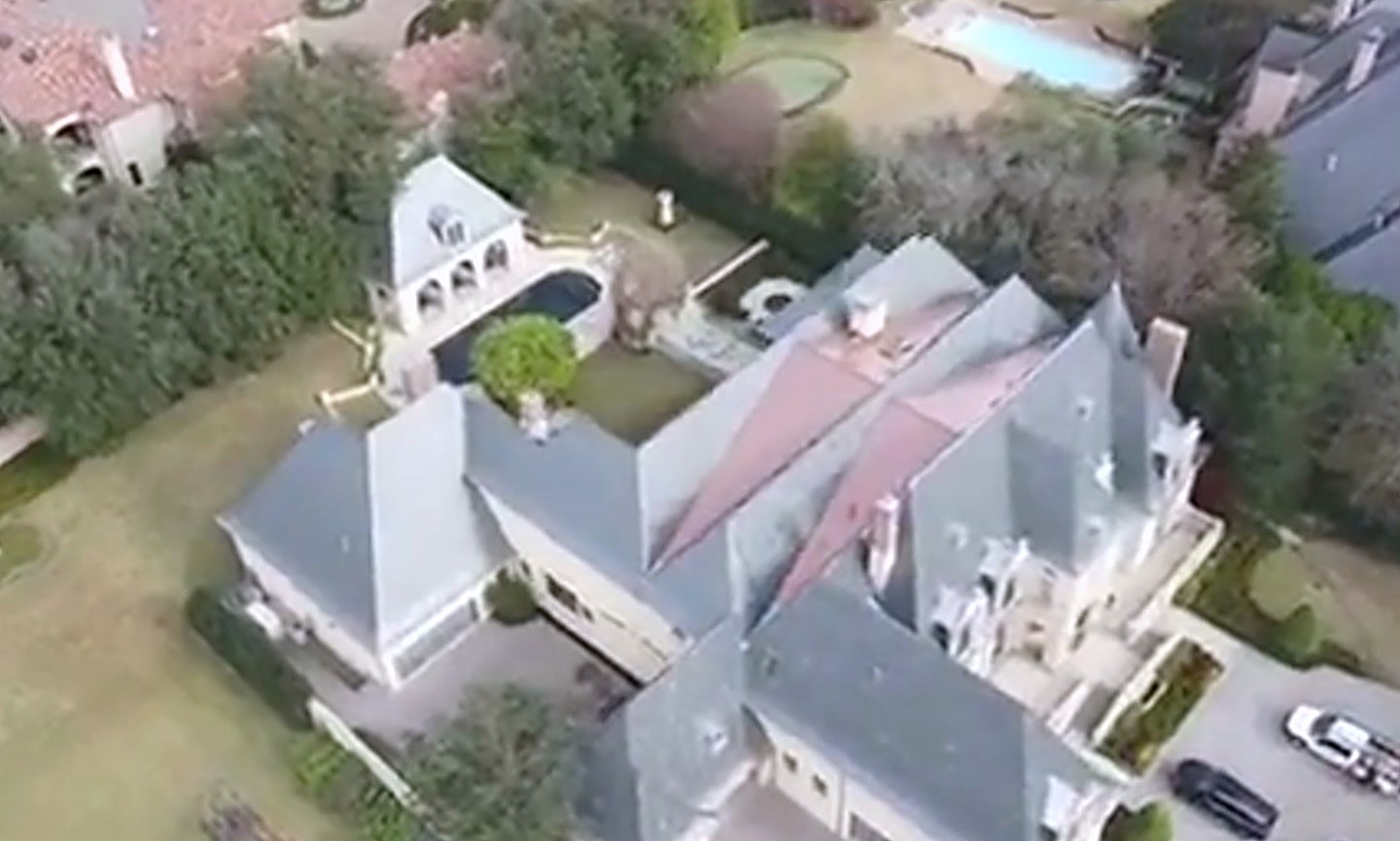 A wide roofline of hips, gables and valleys on a large home, seen from above